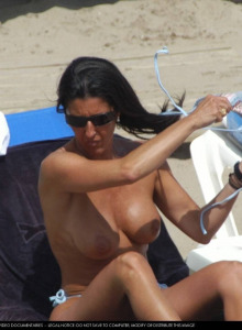 Hot topless chicks on the beach show their large tits