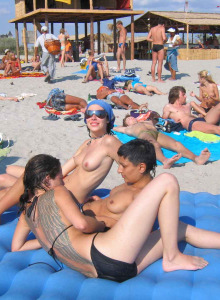 Sexy topless babes on the sand beach